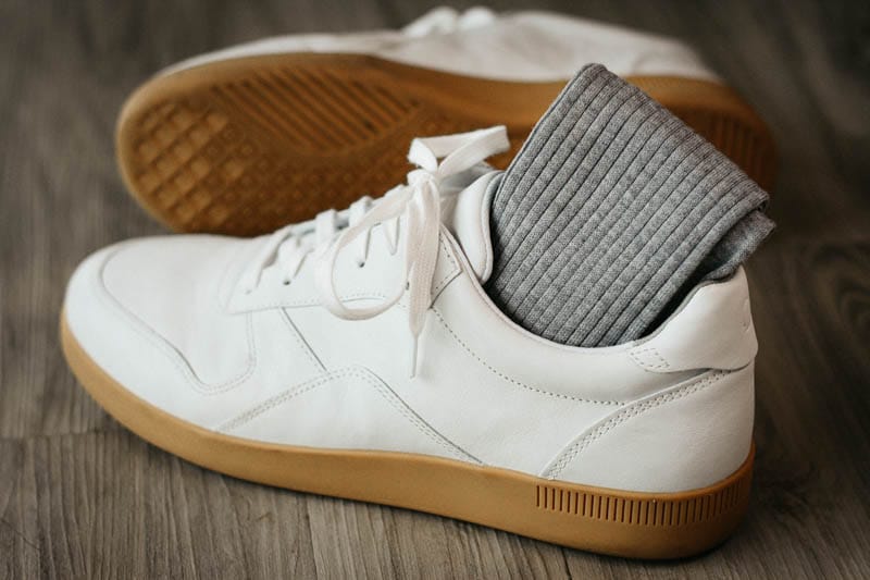 asket grey ribbed cotton socks tucked into white everlane tread sneakers