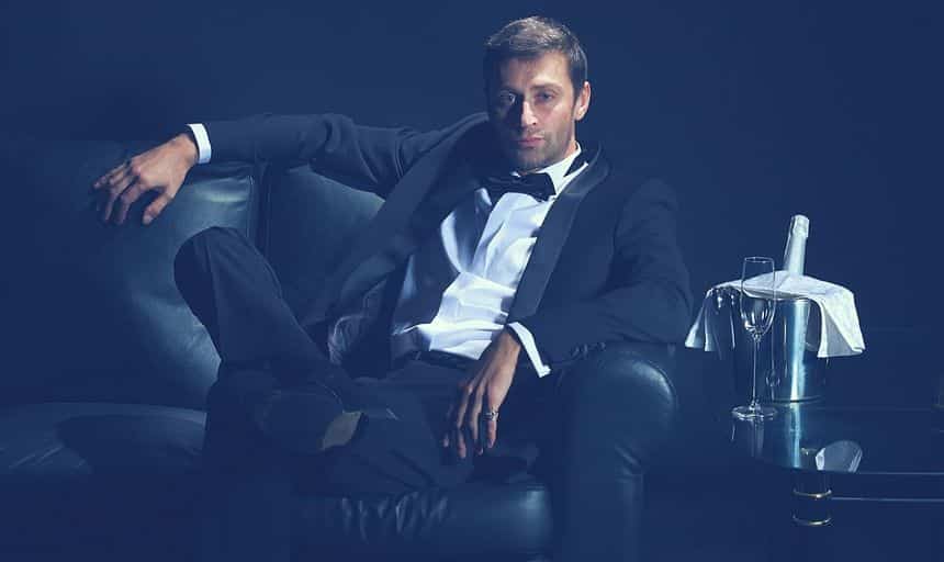 Attractive man in tuxedo sitting down