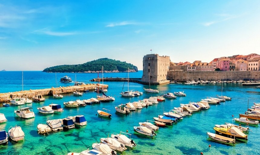 Beautiful sunny day over the bay in front of old town of Dubrovnik, Croatia with boats