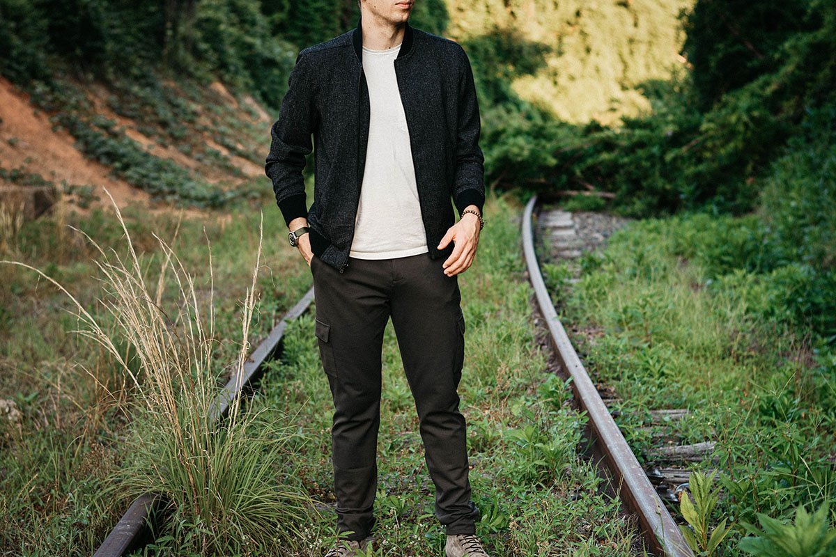 Best Bomber Jackets for Men Male model wearing Paige Bomber Jacket and Cargo pants on railroad track outside