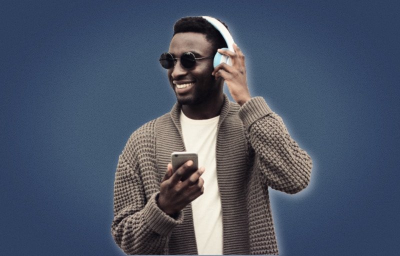 Best Podcasts for Men African American Model Smiling While Wearing Headphones and Phone