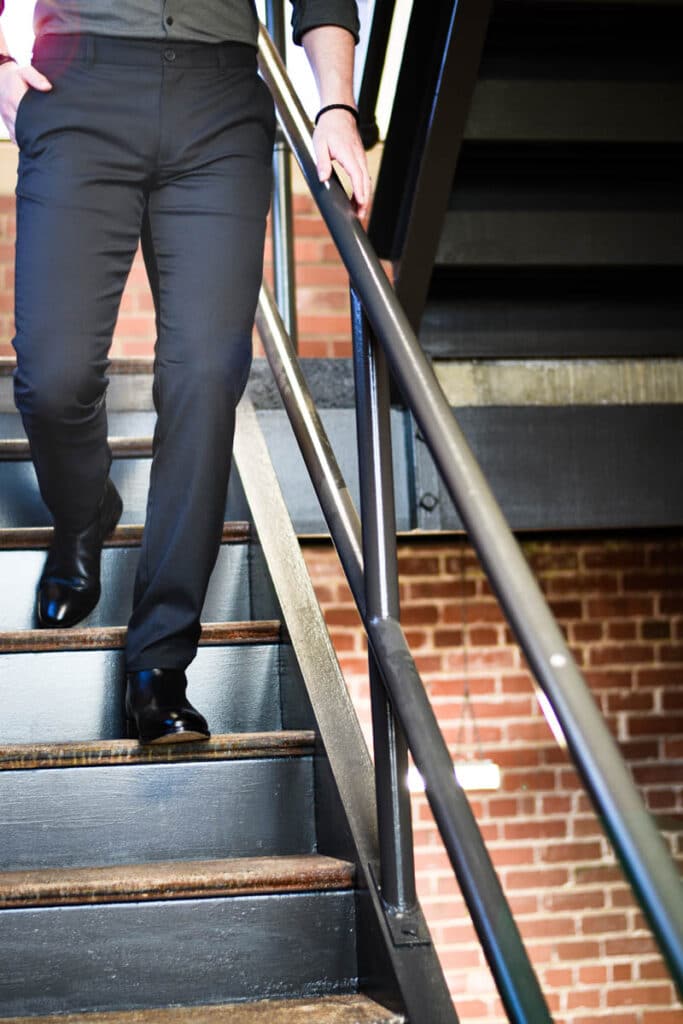 Black Mizzen Main Performance Chino on Model Walking Down Stairs