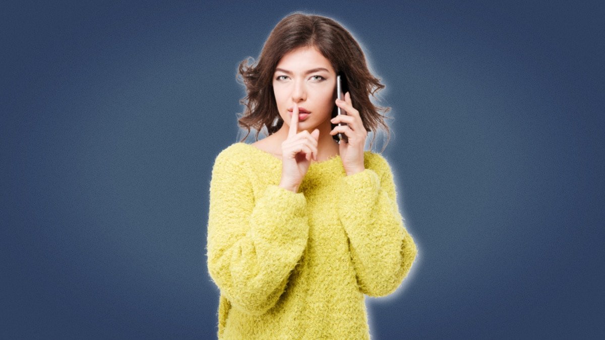 Cheating Girlfriend Girl in yellow sweater on phone making shh noise