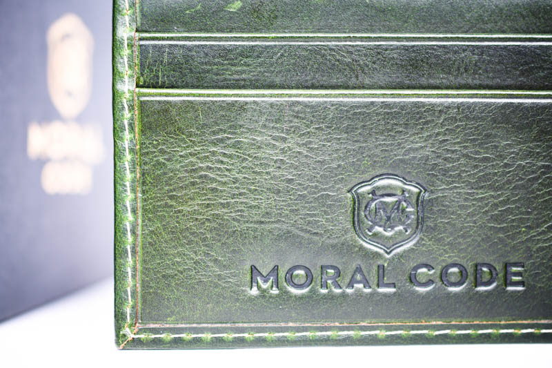 closeup green leather moral code wallet