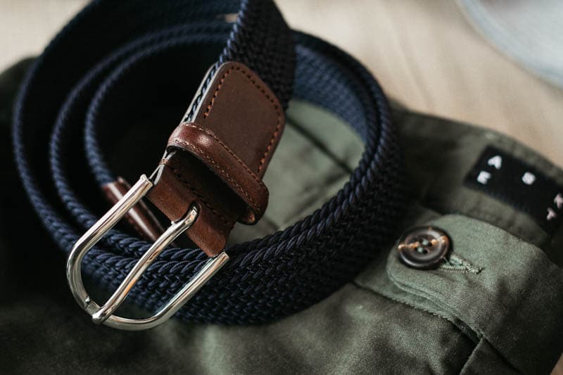 closeup navy woven belt details with horn button on asket chino