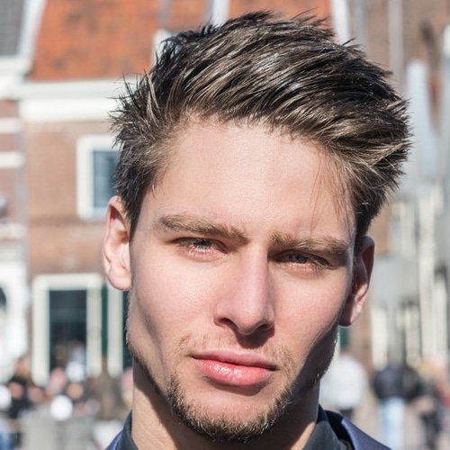 closeup of man with square face high cheekbones and medium hairstyle