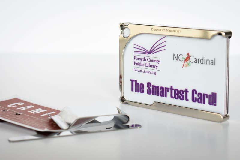 Decadent Minimalist DM1 wallet and stainless steel money clip on white background