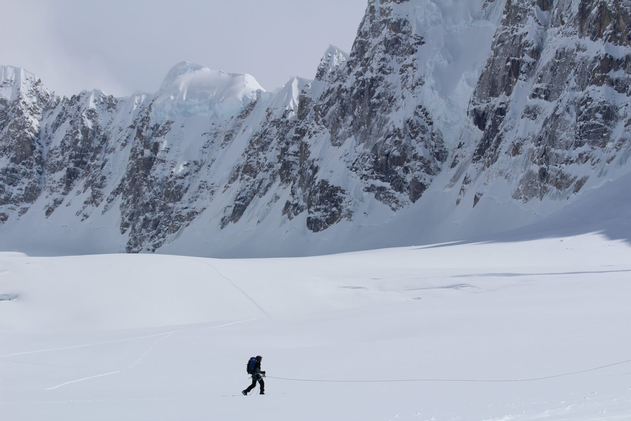 Denali Basecamp lone man against white mountain travis khachatoorian