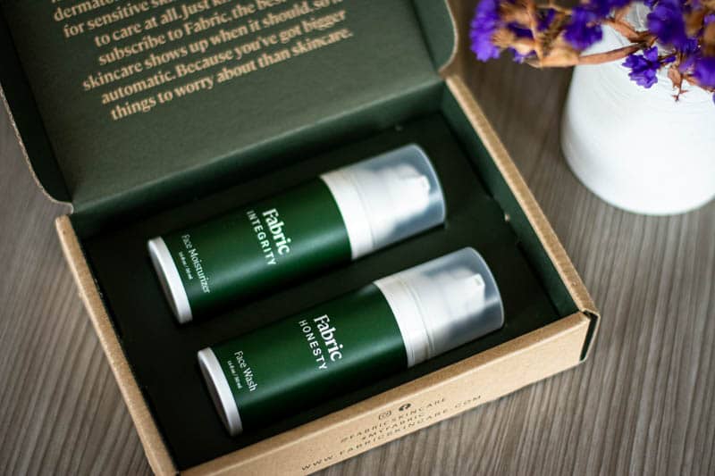 facial care products in sample packaging with purple flower