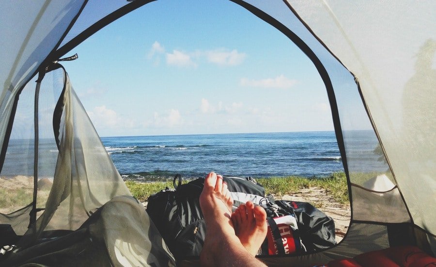 Man's view of ocean from tent