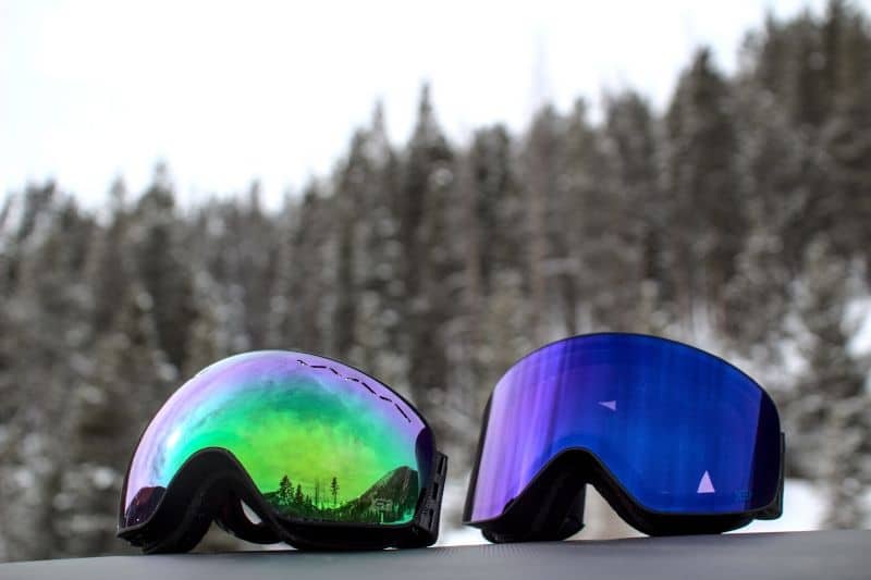 Float and inuit goggles on mountain in snow pine tree background