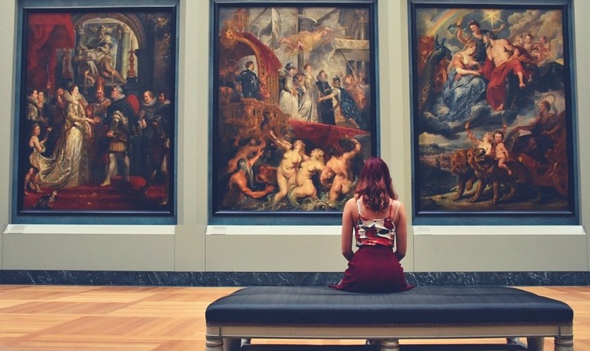 Girl sitting down admiring classical art