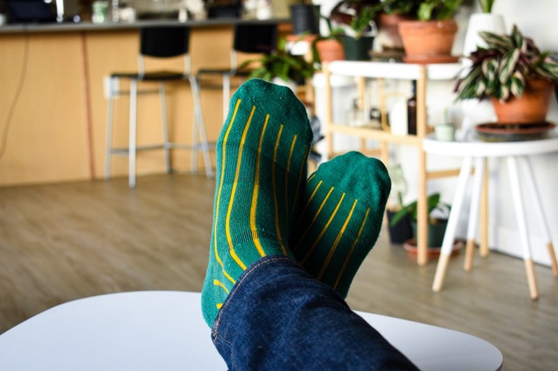 green and gold lignes dor pair of thieves socks on model