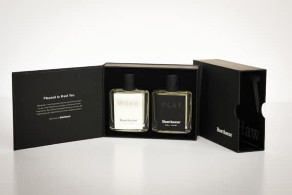 Hawthorne Fragrance Box Packaging Open Showing Work and Play Side by Side With Package in Background on Angle Smaller Size