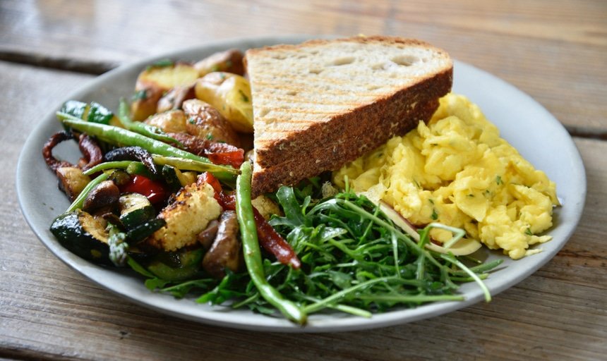 Healthy meal of toast, eggs, vegetables, and salad