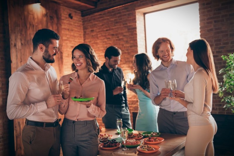 House party gathering with young people eating and drinking