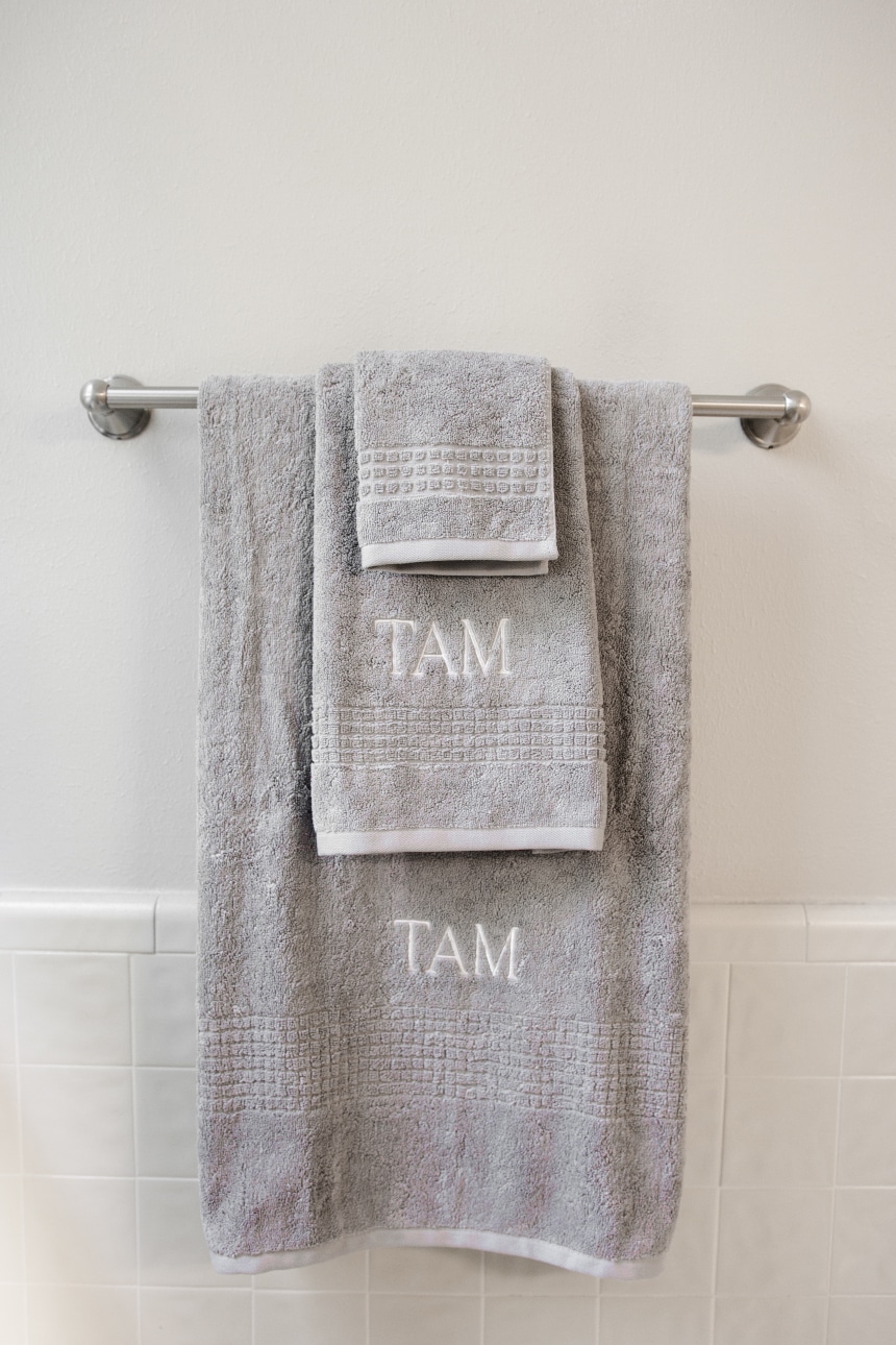Luxor Linens Valentino Luxe Egyptian Cotton Spa Towels Monogrammed and hanging on rack front on