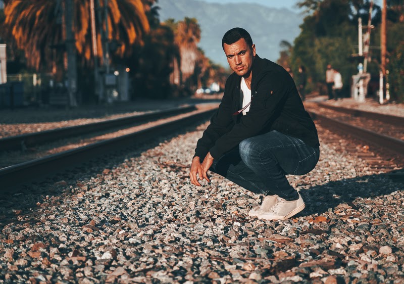 How Military Style Can Level Up Your Closet: The Complete Guide for Men 18 Man crouching in black bomber