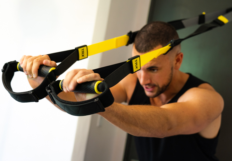 Man doing triceps TRX 1