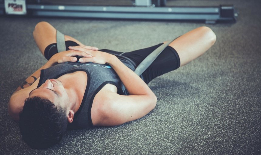 Man fatigued on the ground in training gear