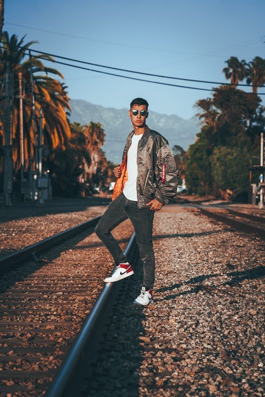 How Military Style Can Level Up Your Closet: The Complete Guide for Men 4 Man in bomber jacket on train tracks