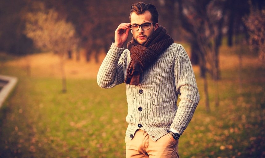 Man in glasses with cardigan and scarf outside