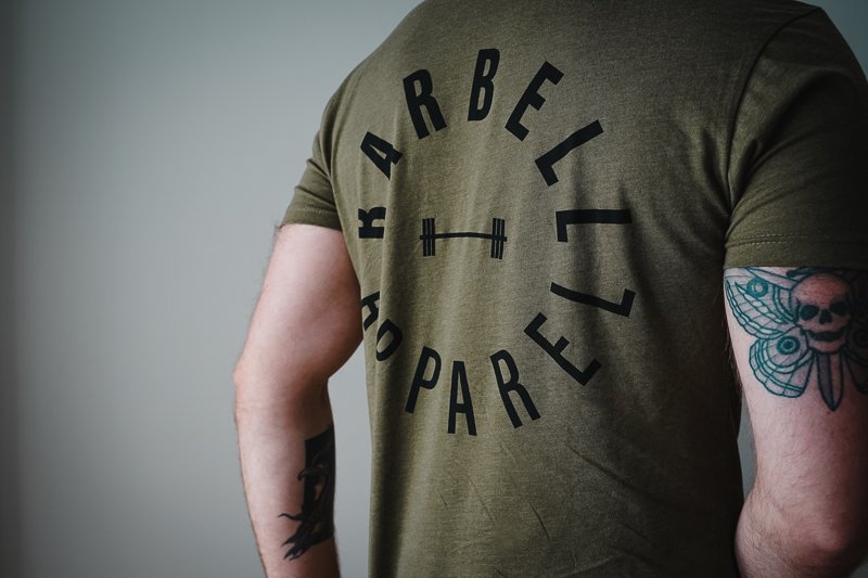 man in green barbell shirt from behind