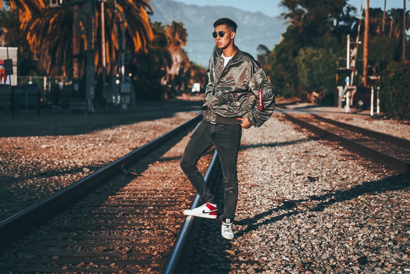 How Military Style Can Level Up Your Closet: The Complete Guide for Men 19 Man in grey bomber jacket on tracks