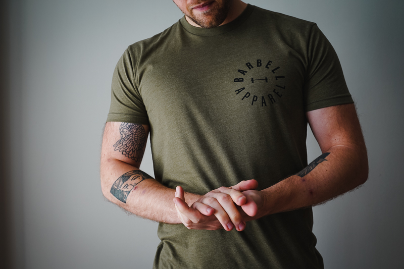 Man indoors in green Barbell shirt