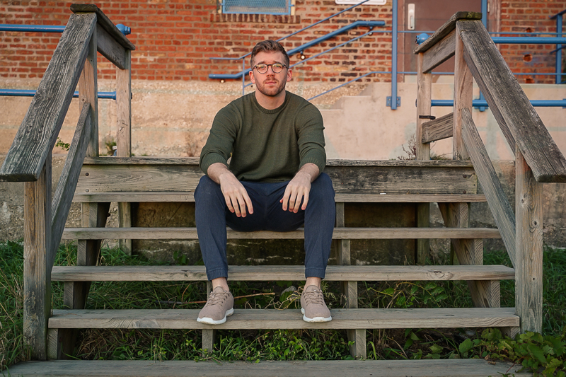 Man on steps wearing Unbound Merino sweater