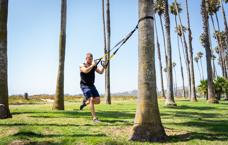 Man outdoors using TRX