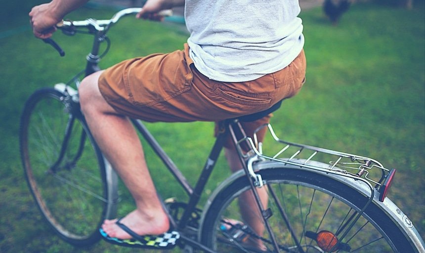 Man riding bike with brown shorts