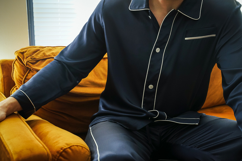 Man sitting on couch wearing Lilysilk pajamas