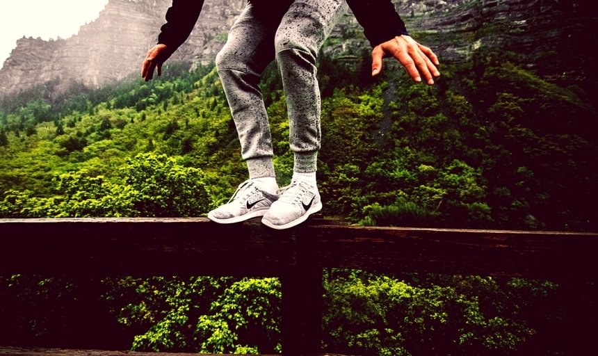 Man sneakers balancing on rail