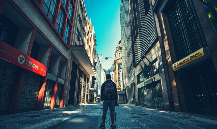 Man standing with camera in urban setting South America