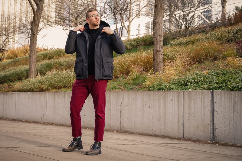 Man wearing black Nobis jacket in park