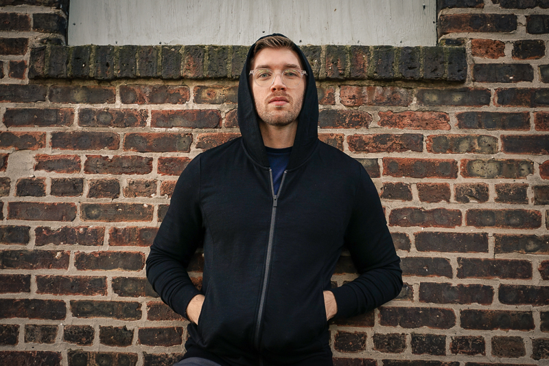 man wearing black Unbound Merino hoodie and pants