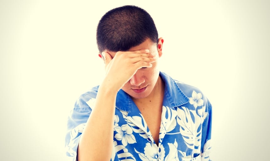 Man wearing hawaiian shirt and ashamed