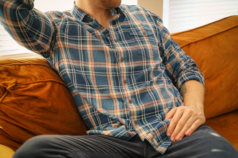 Man wearing Johnnie O shirt on couch