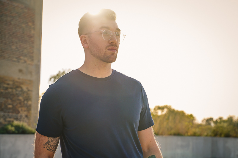 Man wearing Unbound Merino tee on rooftop