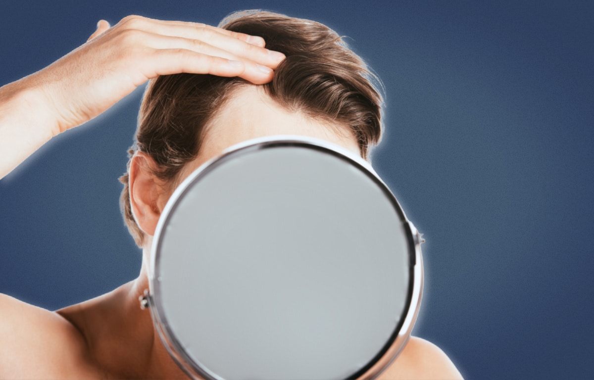 Mature Hairline Man Inspecting Hairline Behind Mirror