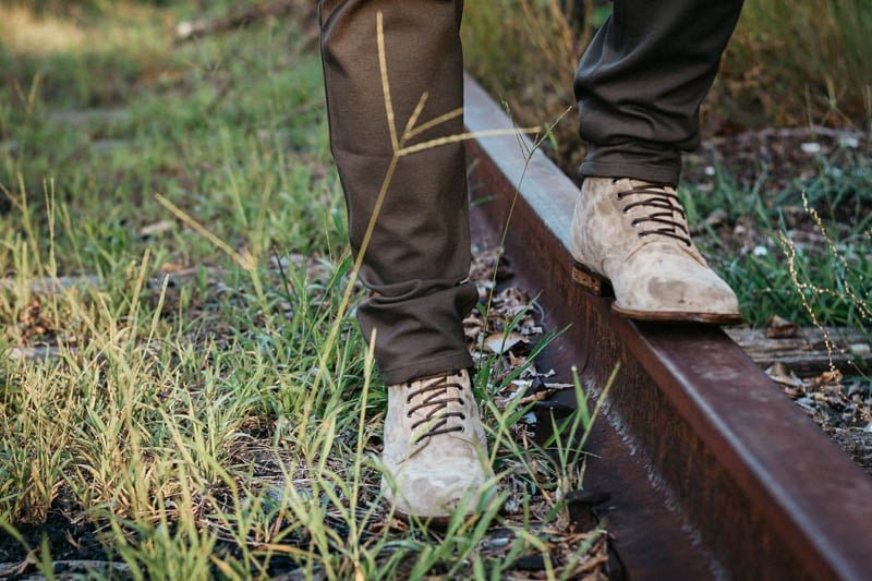 MGemi Boots suede fuggire model standing on train tracks