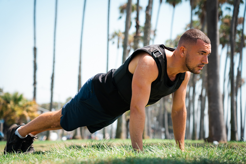 Model doing push up in TRX weight vest