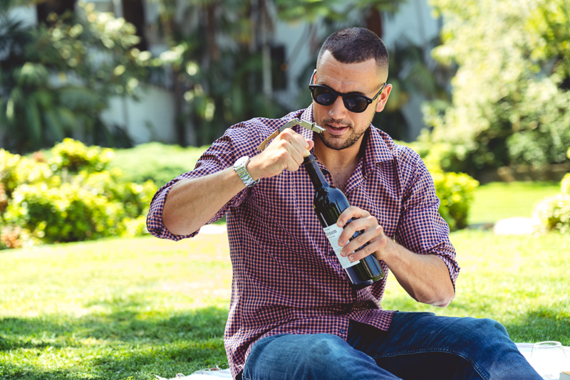 Model drinking wine in park