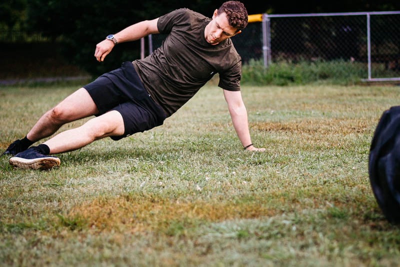 model exercising on grass field wearing vuori workout apparel