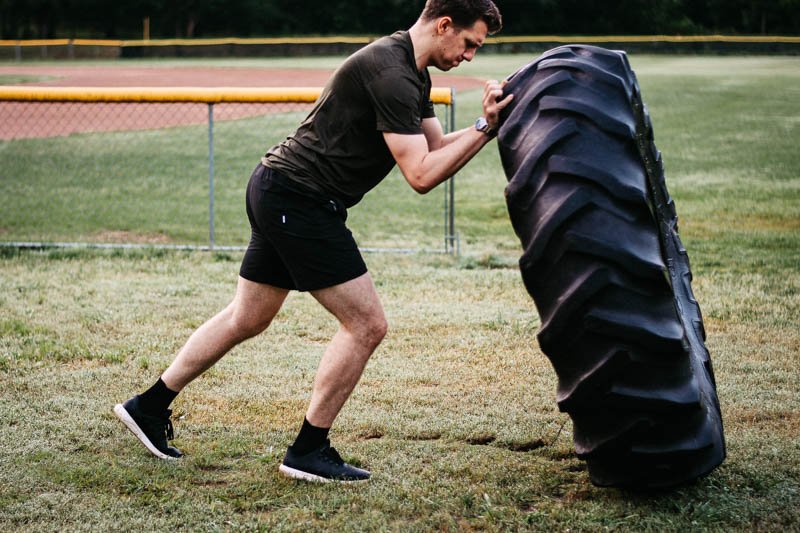 model flipping tire in kore workout shorts from vuori
