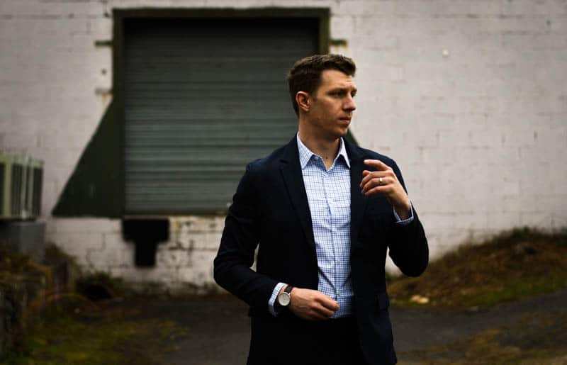 model head turned navy suit and blue checked shirt