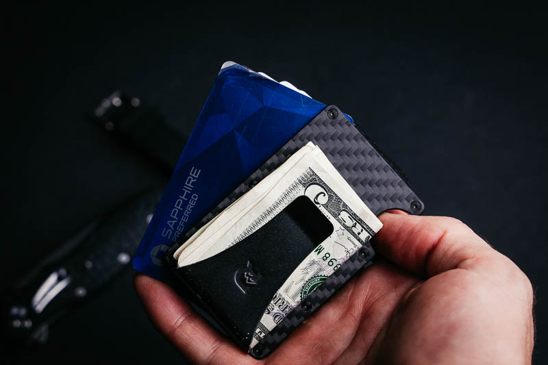 model holding Ridge Wallet with money clip