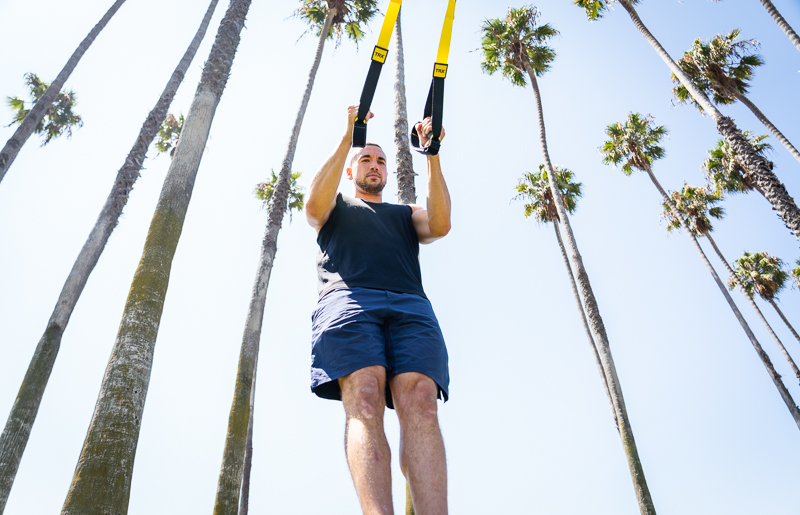 Model holding TRX straps