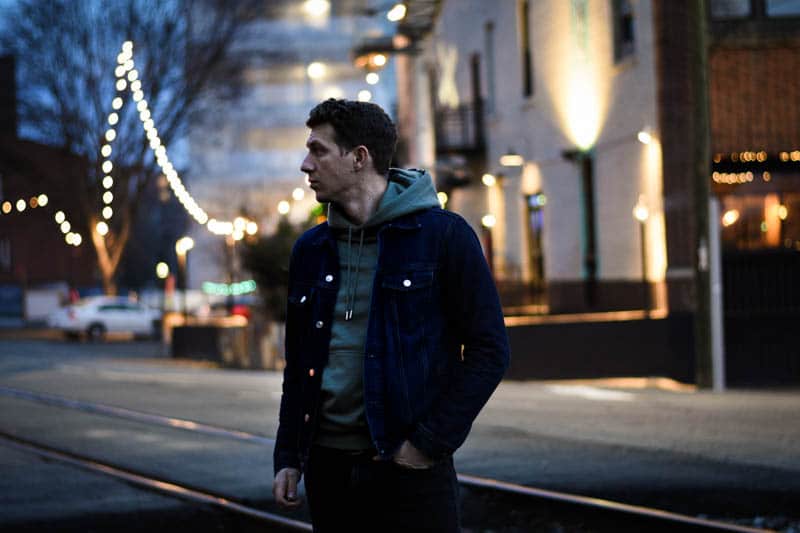 model in front of brightly lit storefront 1